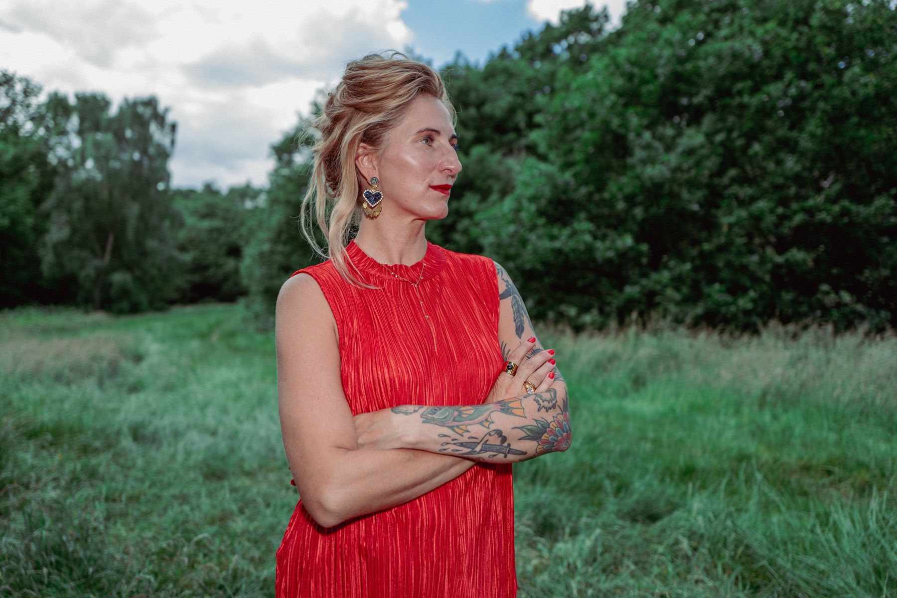 Kamila Kuc, founder of Own Story, standing in a green meadow